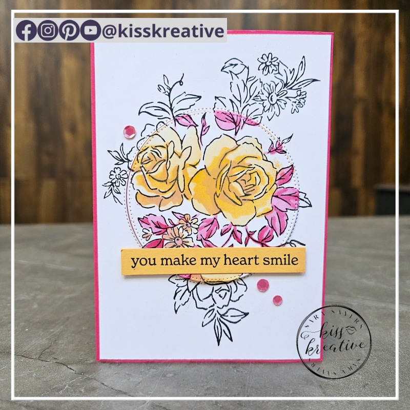 Card with roses and a coloured central cut out circle coloured with inks using a mask